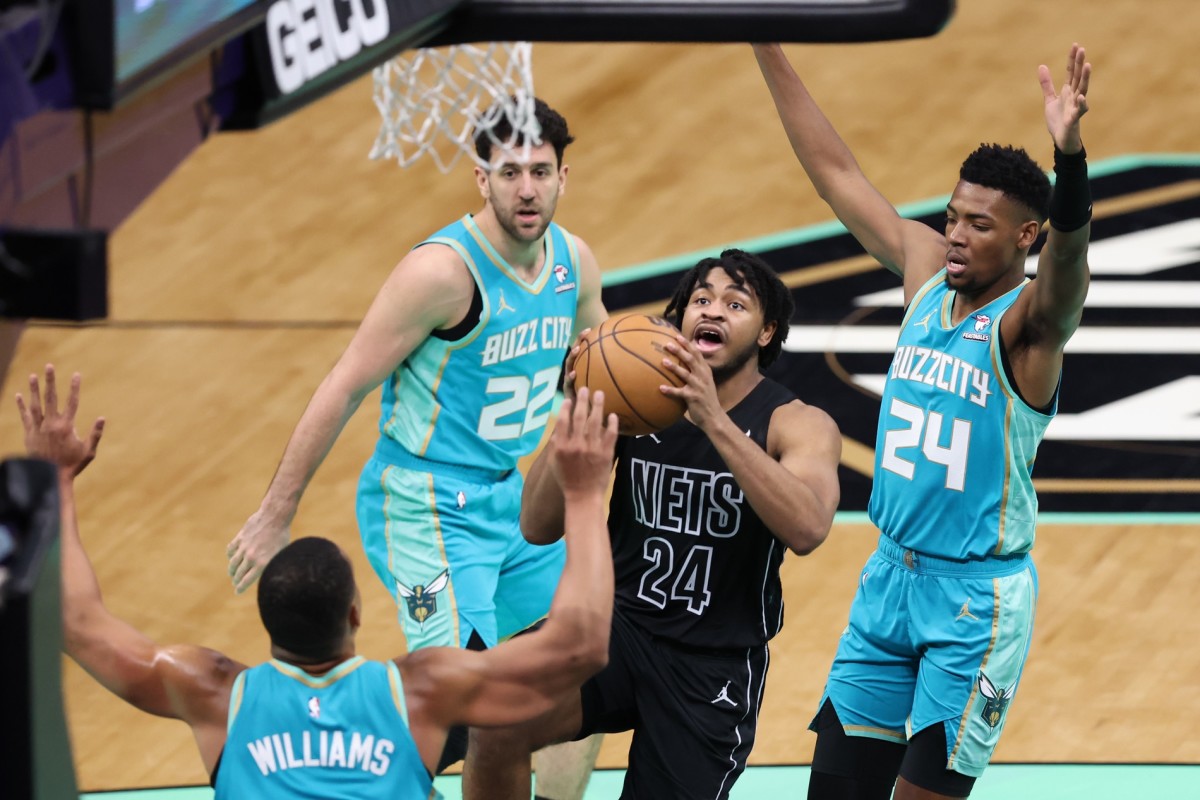  Brooklyn Nets guard Cam Thomas (24) go ups for a layup against Charlotte Hornets forward Brandon Miller (24) during the second quarter at Spectrum Center.